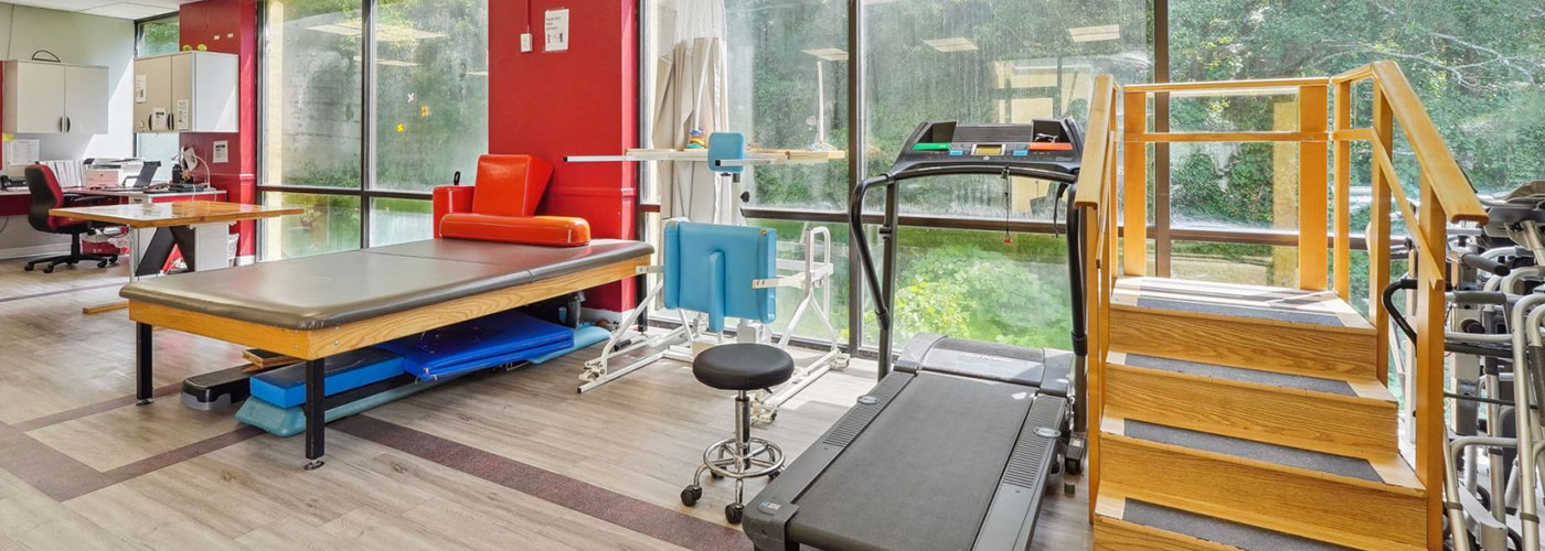 Rehabilitation center with treadmill and stretching table
